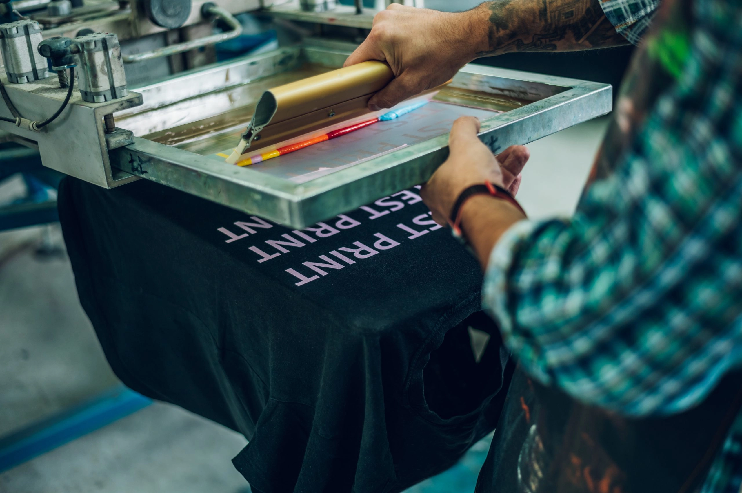 male-worker-pressing-ink-on-frame-while-using-the-2023-11-27-04-58-35-utc-scaled